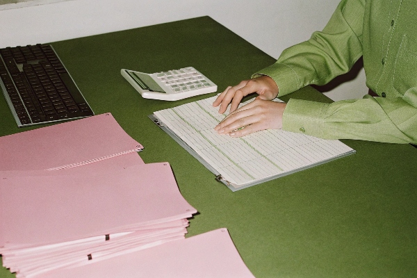 accountant working on a ledger with invoices